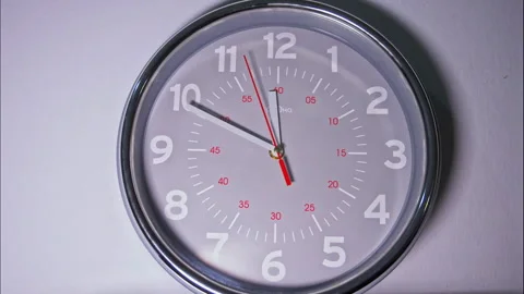 Time-Lapse of a Grey Circular Wall Clock with a Red Second Hand Stock Footage 337897296