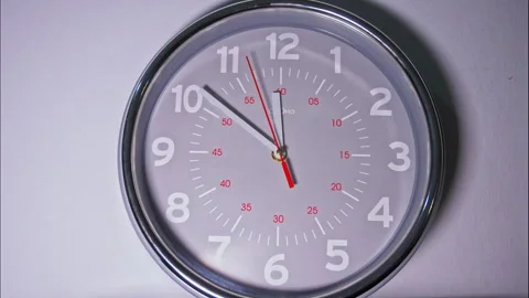 Time-Lapse of a Grey Circular Wall Clock with a Red Second Hand Stock Footage 337897740