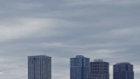 Time-lapse of Grey Clouds Moving Over Modern Residential Skyscrapers in Japan Stock Footage 334388500