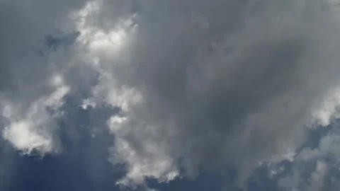 Time-lapse of grey smoky looking clouds churning and moving with the sun Stock Footage 314527978