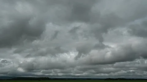 Time lapse of grey storm clouds above a flat prairie landscape.  Stock Footage 248395180