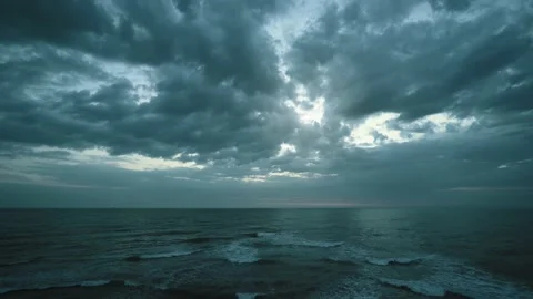 Time lapse of grey stormy clouds over dark blue evening sea Stock Footage 151802032