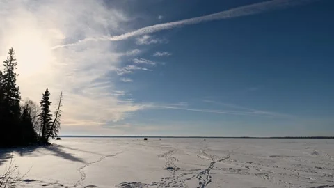 Time lapse of groups of ice fishermen on a large snow-covered lake.  Stock Footage 144483952