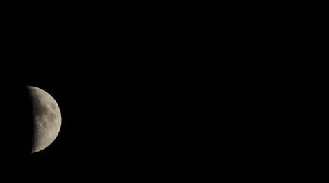 Time lapse of a half crescent large moon moving across sky medium shot Stock Footage 56831357