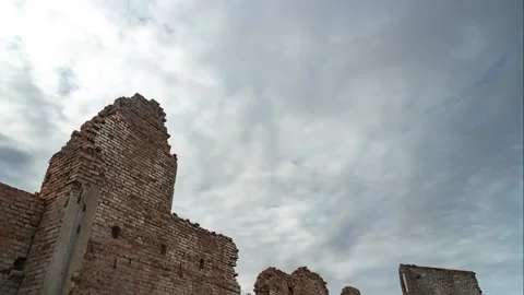 Time Lapse: a half-destroyed brick wall and a dramatic cloudy sky. Stock Footage 162668592
