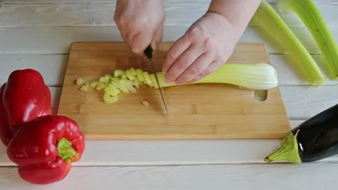 Time lapse of hands slicing a celery stick on a wooden cutting board ProRes Stock Footage 168767821