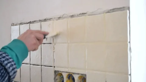 Time lapse with hands of tile worker filling gaps between tiles Stock Footage 75260059