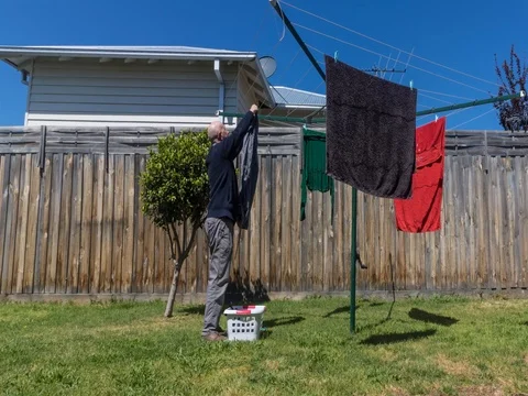Time Lapse - hanging out the washing, washing drying on the line Stock Footage 80905602
