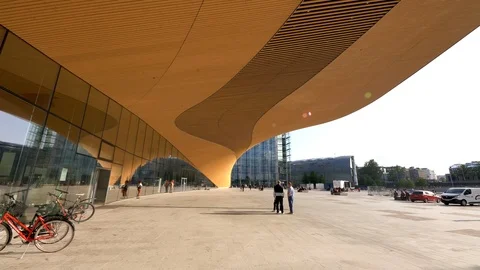 Time lapse of Helsinki Central Library Oodi entrance, warm yellow light. Video stock 117360238