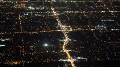Time lapse high angle birds eye view of an urban sprawl grid at night Stock Footage