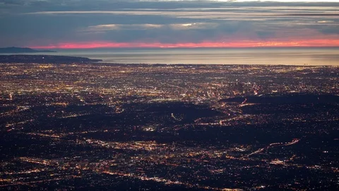 Time lapse high angle view of Los Angeles lights and the Pacific coast at sunset Stock Footage 71307957