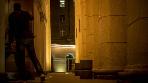 Time lapse on how a man stands near the columns of a large public building Stock-Footage 129558700