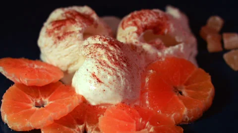 Time-lapse of ice-cream melting, with fresh orange fruits Stock Footage 35139850