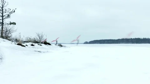 Time-lapse of ice sailing with a kitewing at a frozen lake Stock Footage 71379677