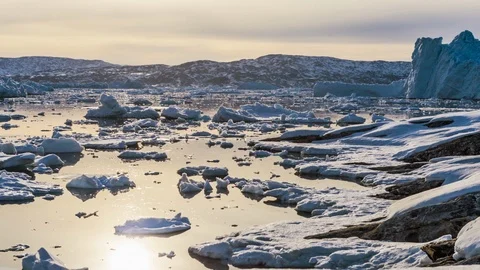 Time-lapse of icebergs floating on the sea surface at sunset Stock Footage 113268683