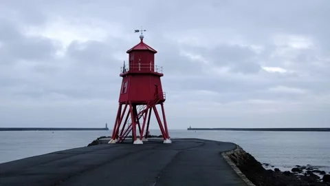 Time-lapse of the iconic red Herd Groyne Lighthouse Stock Footage 337466889