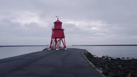 Time-lapse of the iconic red Herd Groyne Lighthouse Stock Footage 337467031