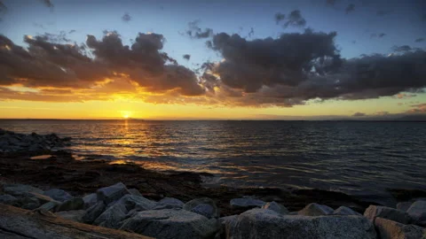 Time Lapse Idyllic Shot Of Dramatic Sky Moving Over Sea During Sunset - British Stock Footage 160314449