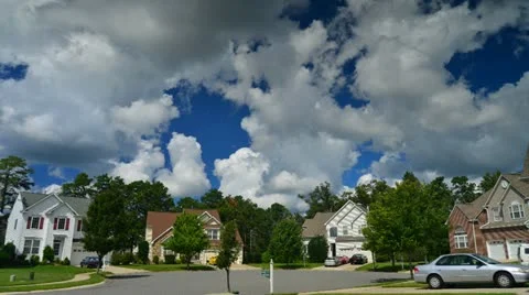 Time lapse of idyllic suburbs with homes on a cul de sac and rolling cumulus clo Stock Footage 12009013