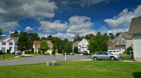 Time lapse of idyllic suburbs with homes on a cul de sac and rolling cumulus clo Stock Footage 12089403