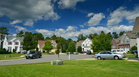 Time lapse of idyllic suburbs with homes on a cul de sac and rolling cumulus clo Stock Footage 12089404