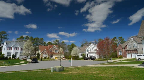 Time lapse of idyllic suburbs with homes on a cul de sac and rolling cumulus clo Stock Footage 26990171