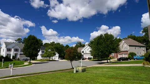 Time lapse of idyllic suburbs with homes and rolling cumulus clouds Stock Footage 79978167
