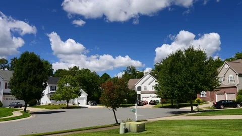 Time lapse of idyllic suburbs with homes and rolling cumulus clouds Stock Footage 80125904