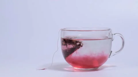 Time-lapse infusion of fruit tea in a transparent cup Stock Footage 147242522