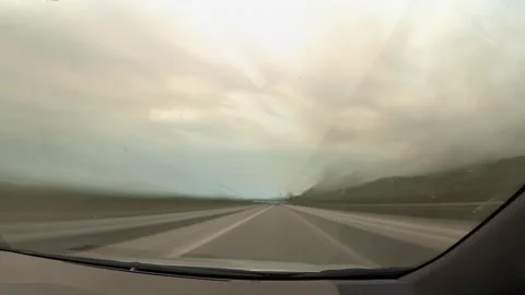 Time lapse from inside a moving car showing dashboard and windshield with c.. Stock Footage 313995672