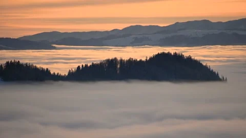 Time lapse of inversion clouds moving in valley at colorful sunset in Slovenia Stock Footage 145373481