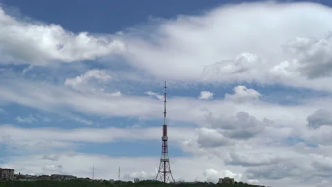 Time lapse of iron communication tower with fast moving clouds. Low angle shot. Stock Footage 195105458