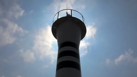Time lapse of iron steel lighthouse with white body and ribbon ring under blue Stock Footage 339367912
