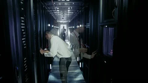 Time lapse of IT engineers working in a data centre Stock Footage 21428228