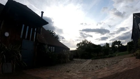 Time lapse from a Kentish barn conversion from day to night, with dogs Video stock 121325460