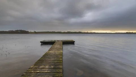 Time Lapse of Lake Jetty with Dramatic Dark Sky Clouds 動画素材 101423173