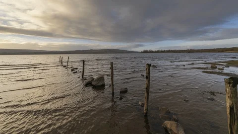 Time Lapse of Lake Shore with Pillars and Rocks on Cloudy Day in Ireland Stock Footage 101608038