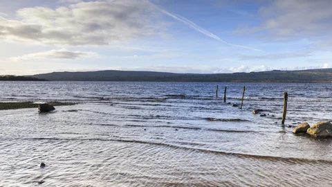 Time Lapse of Lake Shore with Pillars and Rocks on Cloudy Day in Ireland Stock Footage 101613070