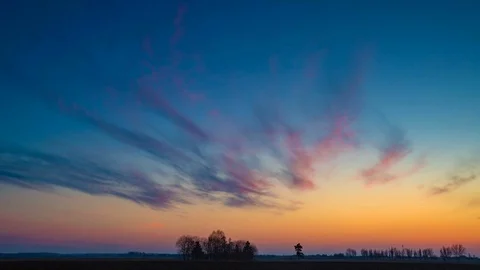Time lapse landscape of after sunset colorful sky over early spring field in Pol Stock Footage 88314999