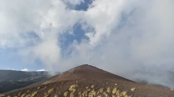 Time Lapse, Landscape with clouds moving above black lava stone and volcano ( Stock Footage 85668413