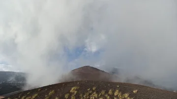 Time Lapse, Landscape with clouds moving above black lava stone and volcano ( Stock Footage 85670944