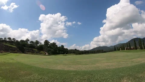 Time lapse landscape moving clouds and golf course Stock Footage 142682570