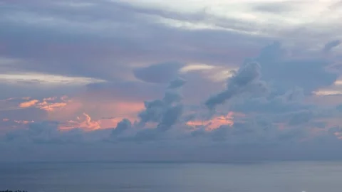 Time-lapse landscape , red purple blue yellow pink clouds are moving fast in the Stockbeeldmateriaal 131132014