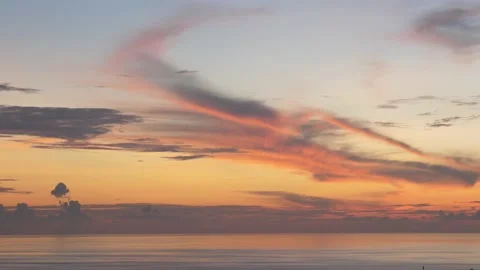 Time-lapse landscape , red purple blue yellow pink clouds are moving fast in the Stock Footage 131132524