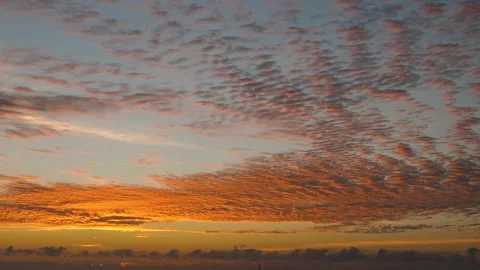 Time-lapse landscape , red purple blue yellow pink clouds are moving fast in the Stockbeeldmateriaal 131132580
