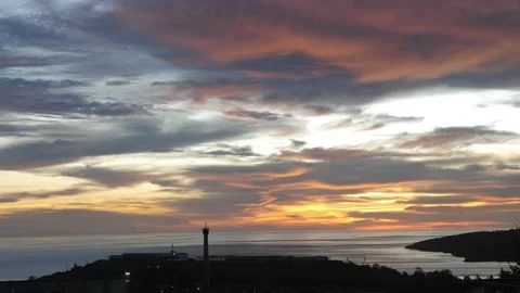 Time-lapse landscape , red purple blue yellow pink clouds are moving fast in the Stock Footage 131133176