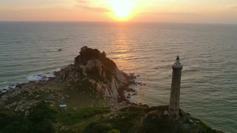 Time lapse landscape of small island with ancient lighthouse at sunrise sky Stock Footage 228659744