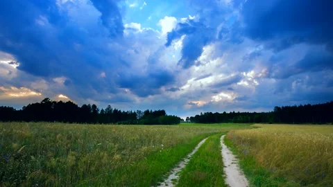 Time lapse landscape with stormy sky over fields in summer. Stock Footage 154351581