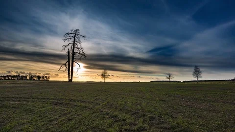 Time lapse landscape of sunset sky over early spring field Stock Footage 73530390