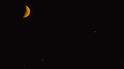 Time Lapse.  Large Blood Moon moves thru sky.  City light visible Video stock 48331811